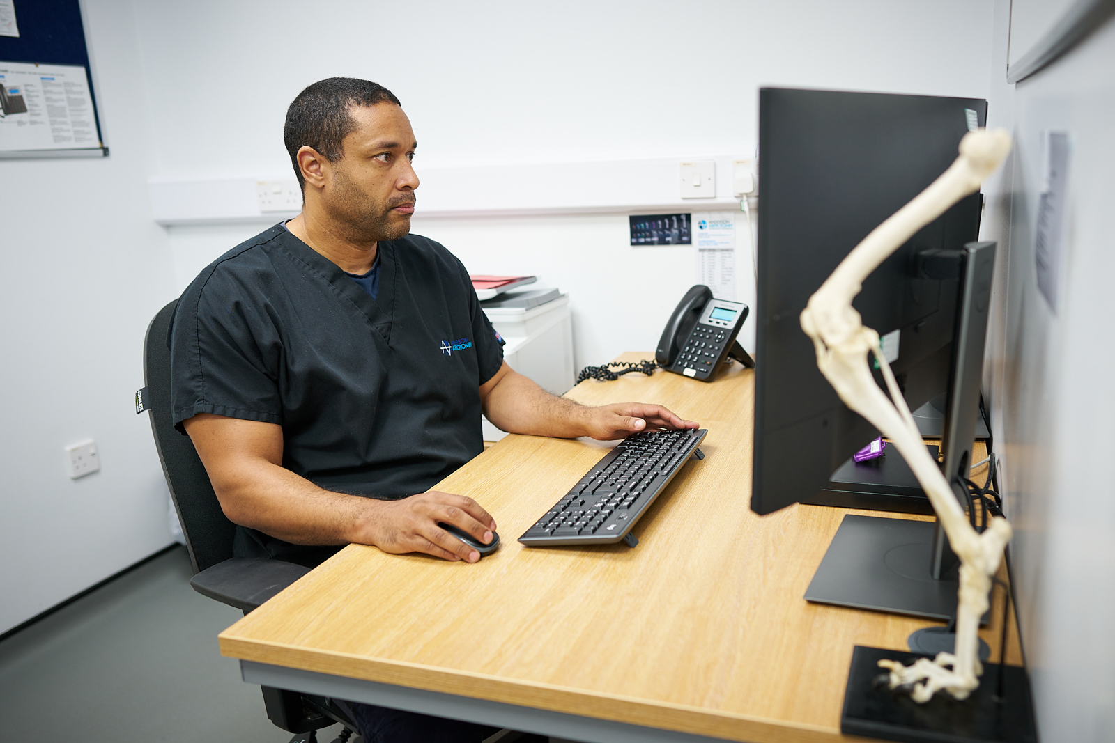 A member of Anderson Abercromby Vet using computer